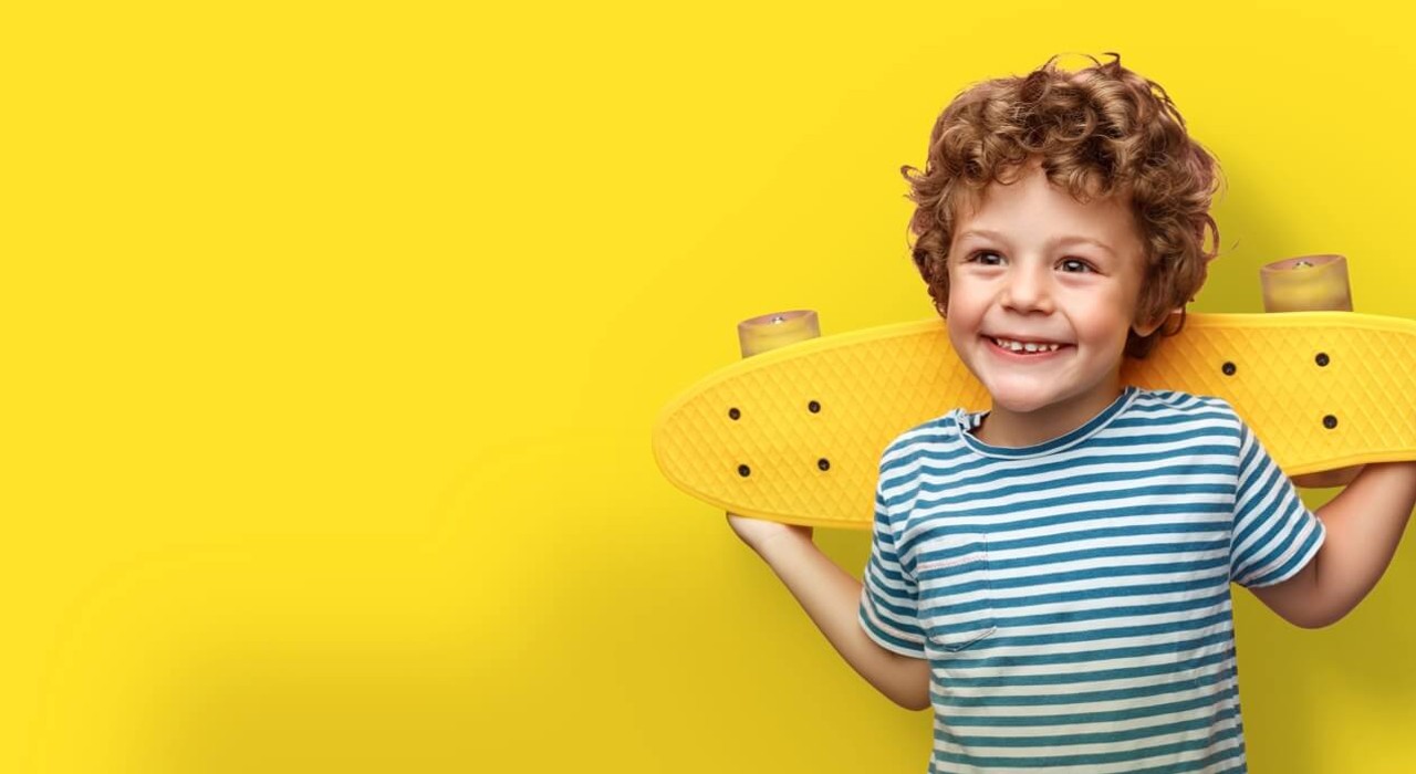 smiling child with skateboard